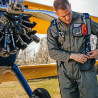 man looks down at Butler back parachute harness