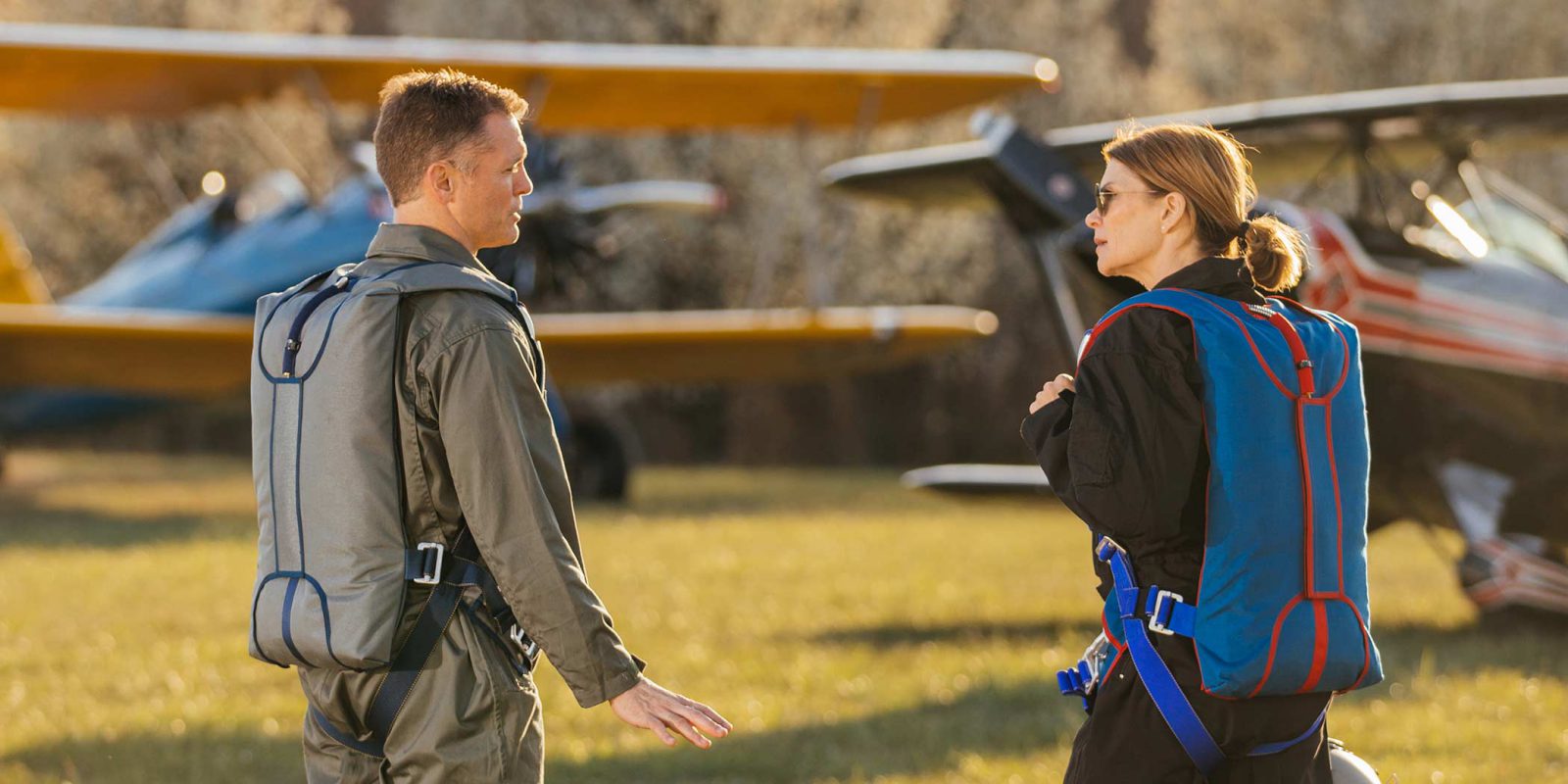 two pilots in conversation with Butler emergency back parachutes on their back