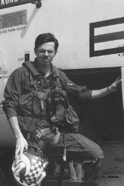 photo of Manley C. Butler, Jr. in front of old airplane