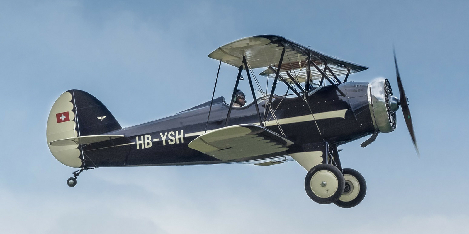 vintage aircraft in flight against cloudless, blue sky